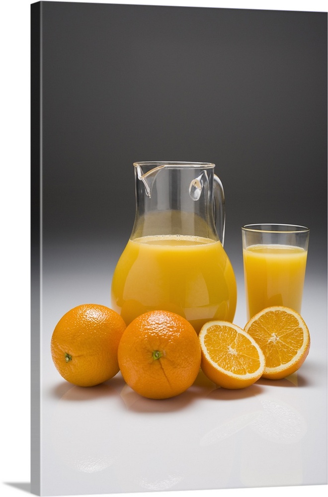Oranges with a Pitcher and a Glass of Orange Juice