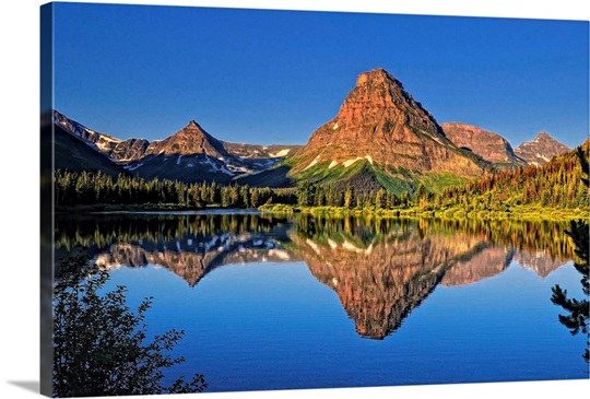 Painted Teepee mountain, Mt. Sinopah and Lone Walker mountain reflected ...