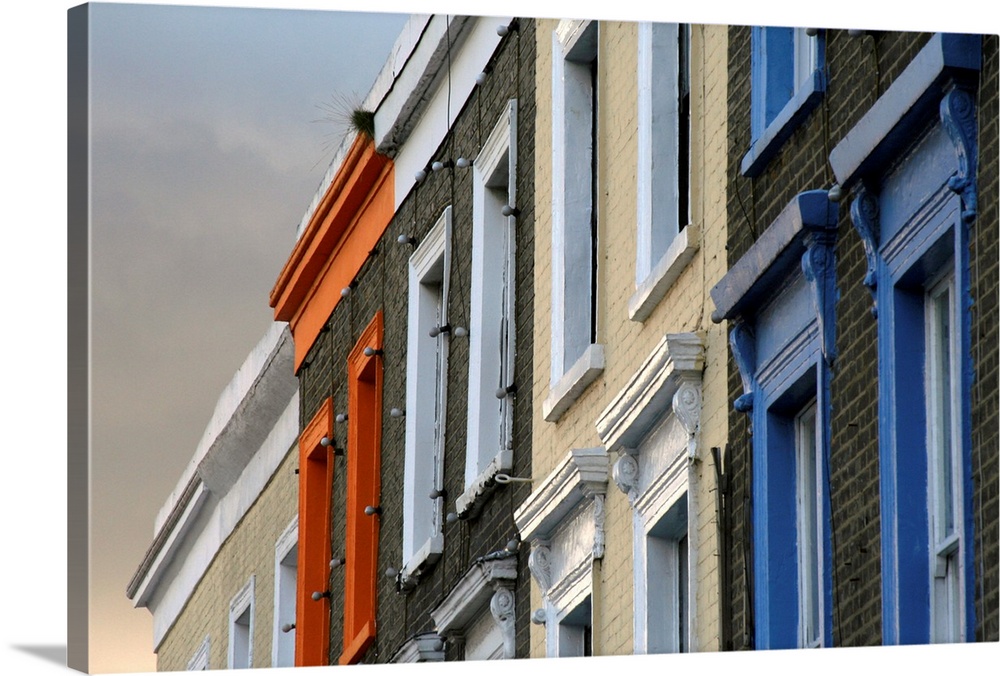 Painted window frames on series of terraced buildings on Camden High Street in London.