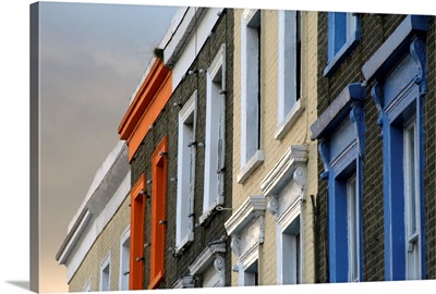 Painted window frames on series of terraced buildings on Camden High Street in London.