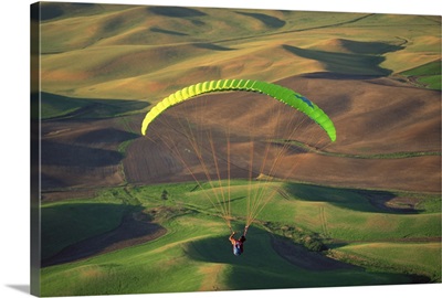 Paraglider flying over fields of Palouse region , Steptoe Butte , Washington