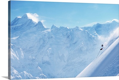 Person downhill skiing in deep powder, side view