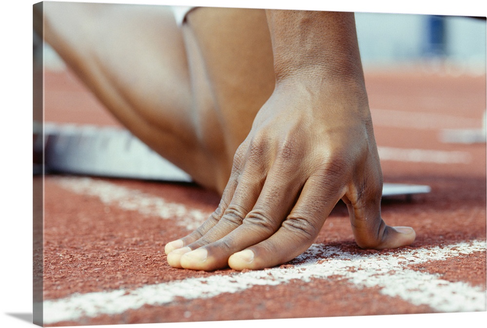 Person kneeling with hands on starting line, Close-up of hand