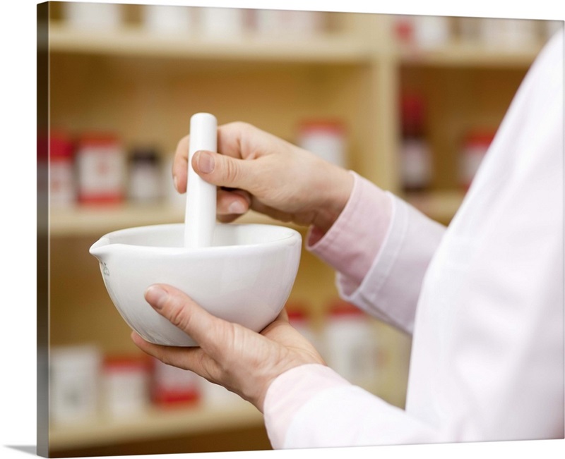 Pharmacist using mortar and pestle Wall Art, Canvas Prints, Framed