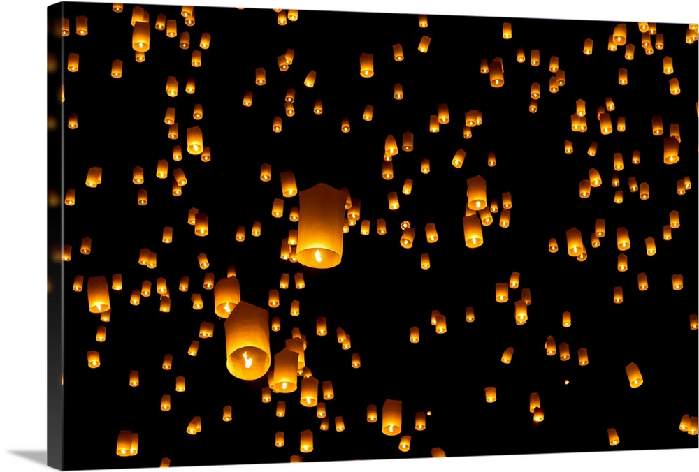 Picture of numerous hot air lanterns in sky floating away at Yee Peng or Yi Peng festival in Chiang Mai province in Chiang...