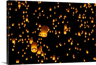 Picture of numerous hot air lanterns in sky at Yi Peng festival in Chiang Mai, Thailand.