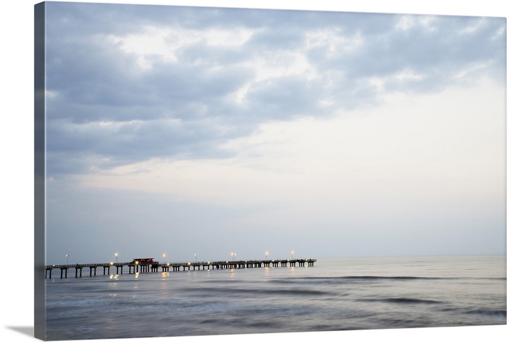 Pier in sea at dusk