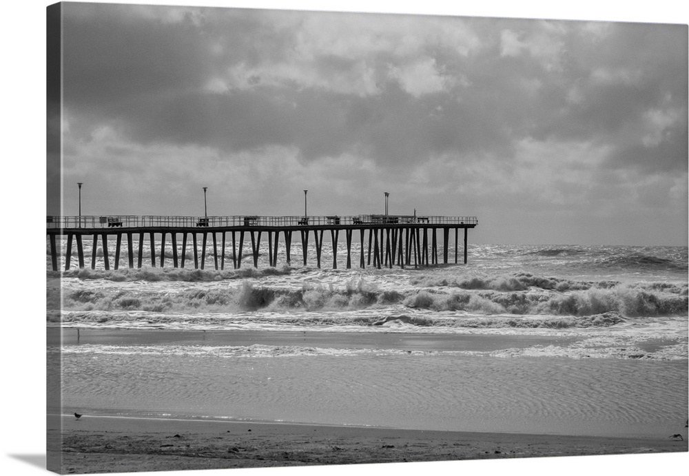 Black and white image of Ventnor Pier in NJ with rough surf caused by an offshore hurricane.