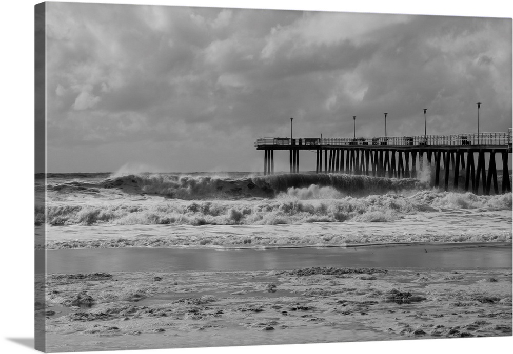 Black and white image of Ventnor Pier in NJ with rough surf caused by an offshore hurricane.