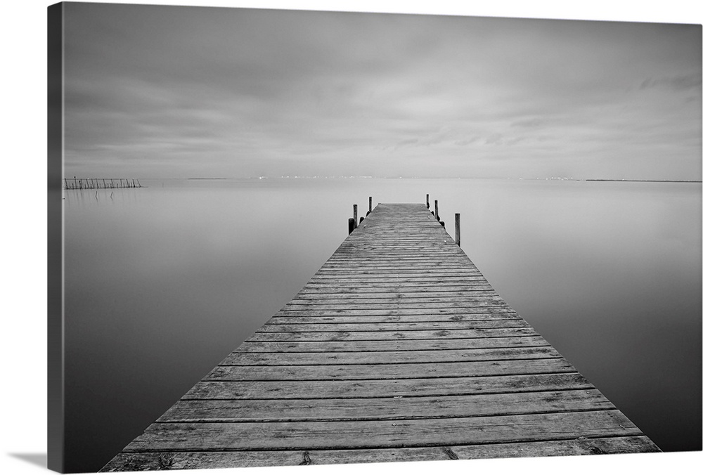Pier on lake black and white image.