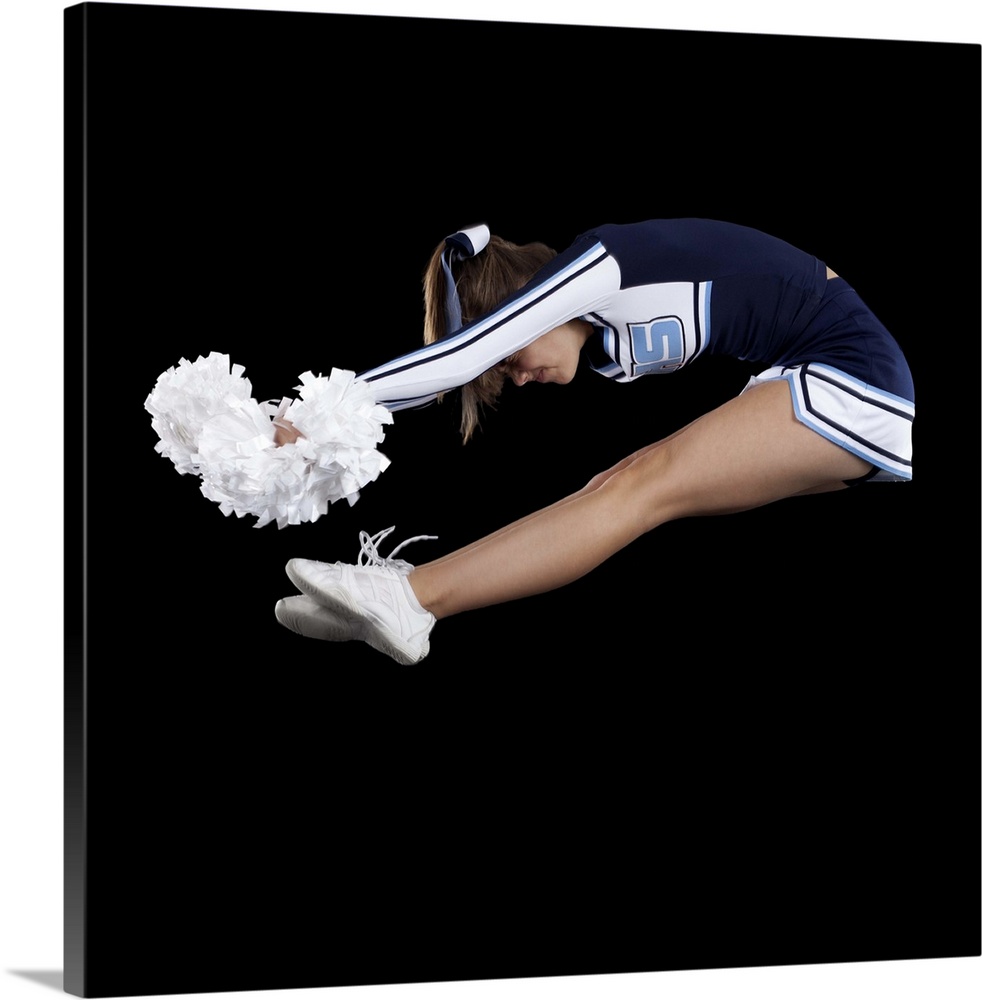 Portrait of teenage cheerleader girl (16-17) jumping