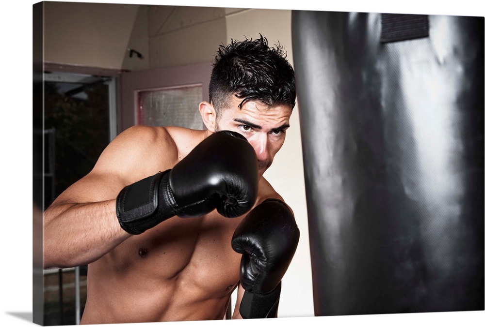 USA, Seattle, Portrait of young man boxing in gym