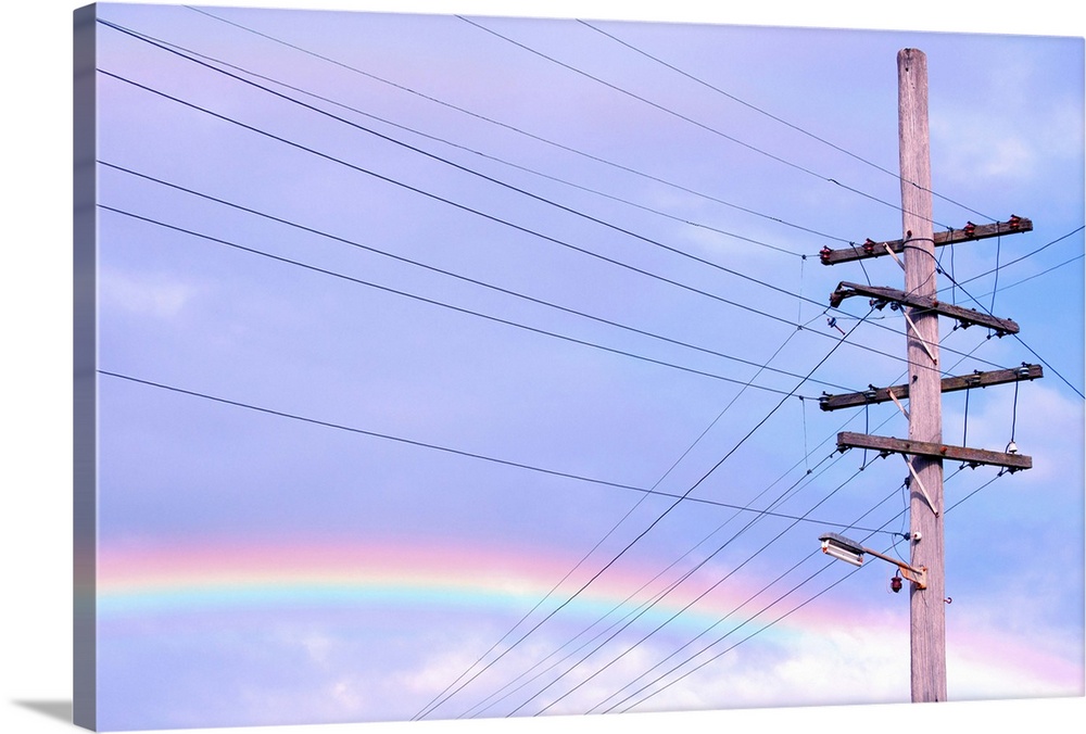 Powerlines against rainbow sky.