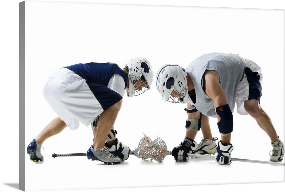 Profile of two young men playing lacrosse