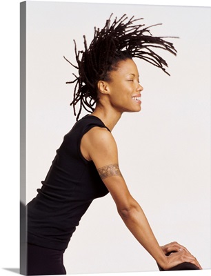 Profile Portrait of a Woman Leaning on a Chair, Tossing Her Dreadlocks