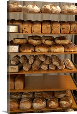 Rack with loaves of bread in bakery