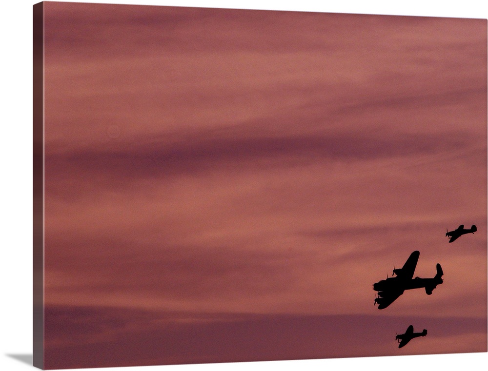 The planes of the Royal Air Force's Battle of Britain Memorial Flight  a 1945 Avro Lancaster bomber, flanked by Hawker Hur...