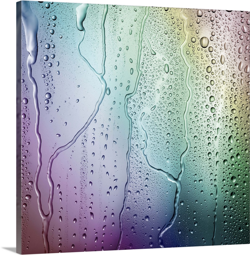 Droplets of condensation form an irregular pattern against a multicolored rainbow background