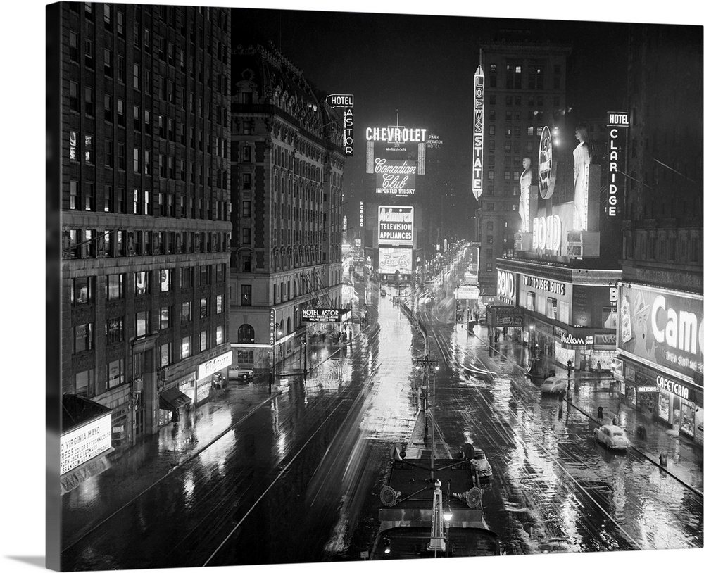 12/5/1952-New York, NY: Times Square on a rainy night takes on an added gleam as the bright lights of Broadway are reflect...