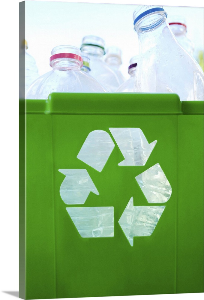 Recycling logo cut out of green plastic container