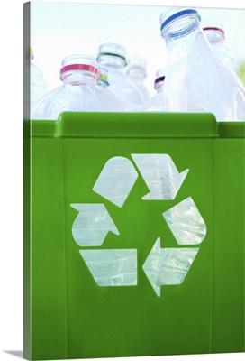 Recycling logo cut out of green plastic container