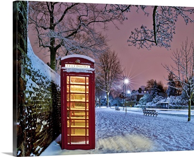Red phone box covered in snow in Hampstead, North London.