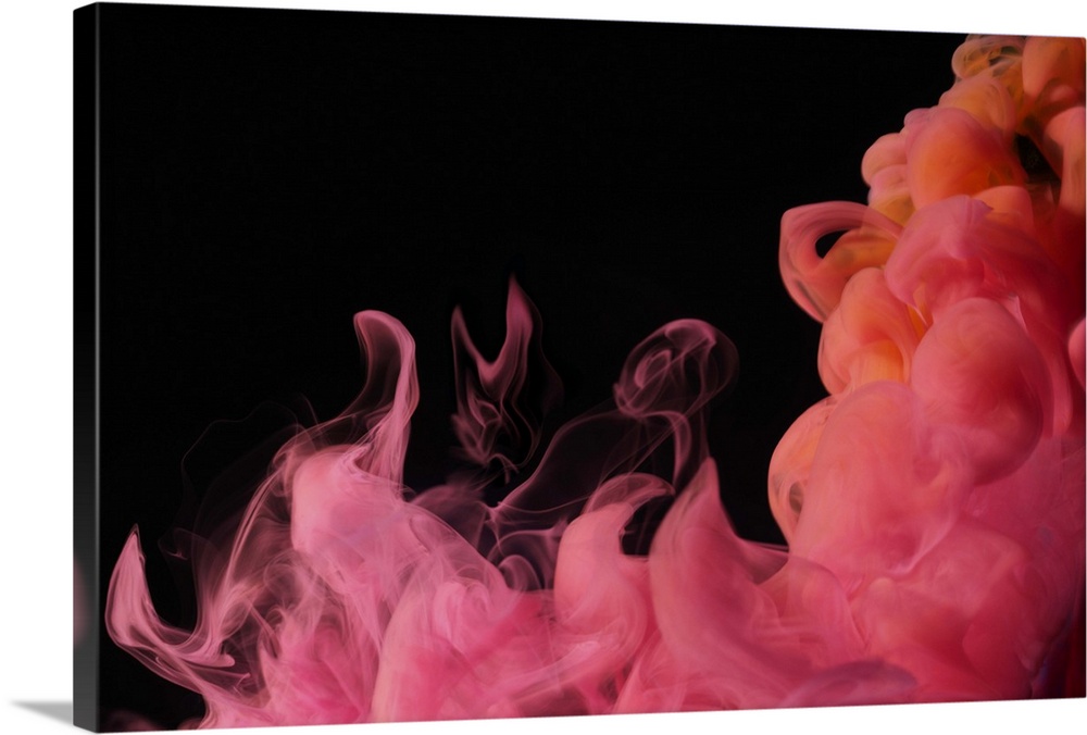 Red colored smoke that rises up and mixes in beautiful abstractions in a dark environment