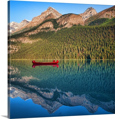 Reflection of mountain and boat in lake, Canada