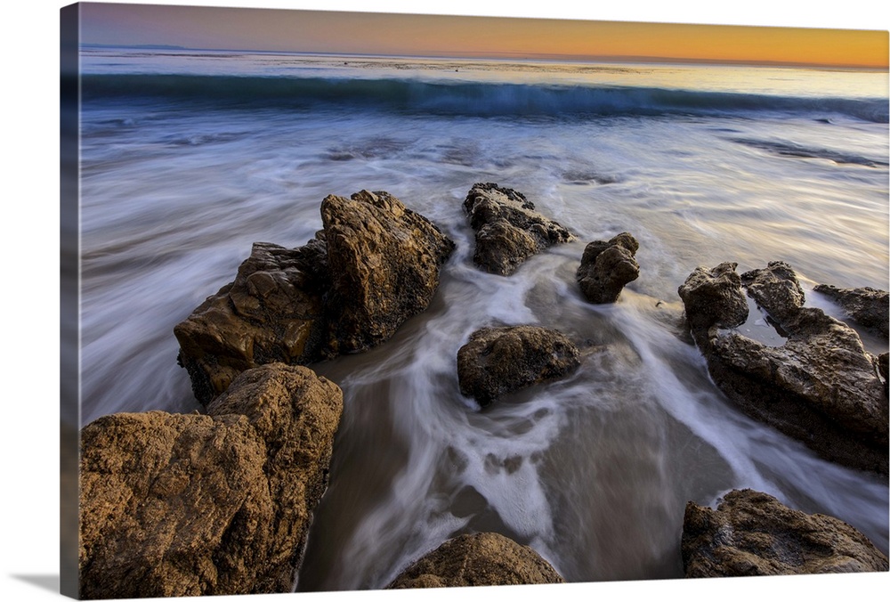 Wave approaching on a rock beach in Malibu, CA