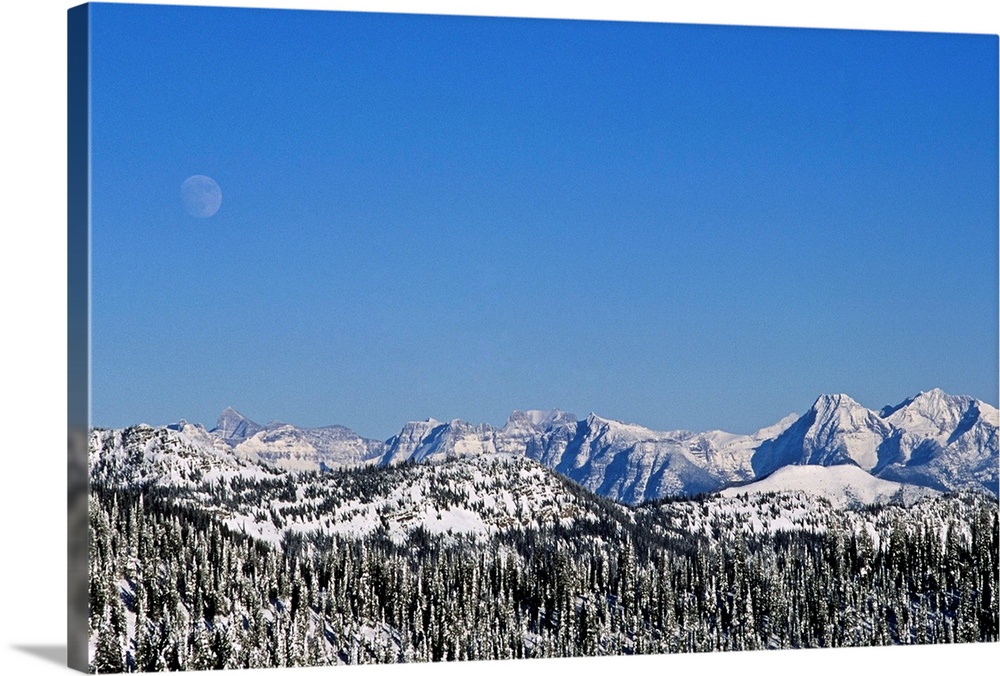 Rocky Mountains & spine of Continental Divide in Glacier National Park, MT during winter seen from Whitefish Range.