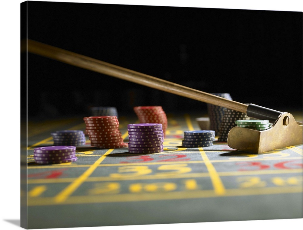 Roulette rake gathering gambling chips on gaming table Wall Art, Canvas