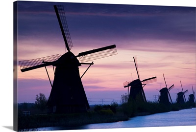 Row Of Windmills At Sunrise In The Netherlands