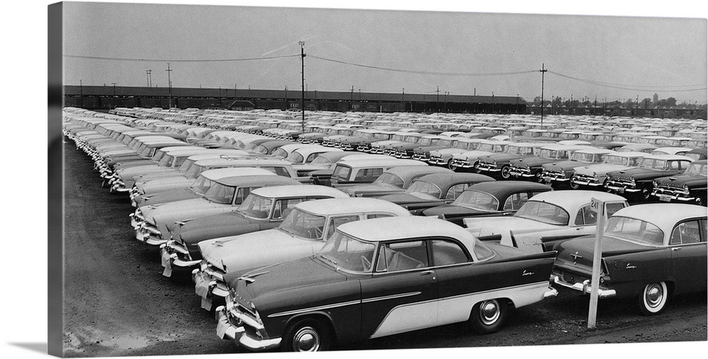 Many Plymouth Motor Cars sedan automobiles stand outside in a row.