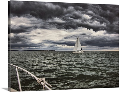 Sail Boat on storm sea and storm clouds
