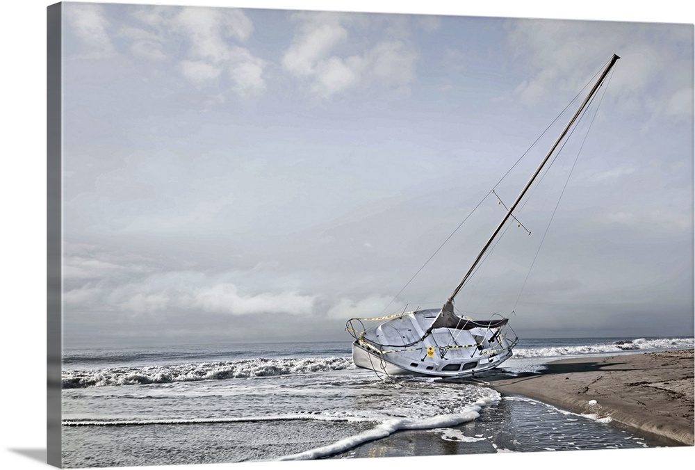 Sailboat grounded  on the beach after a storm.