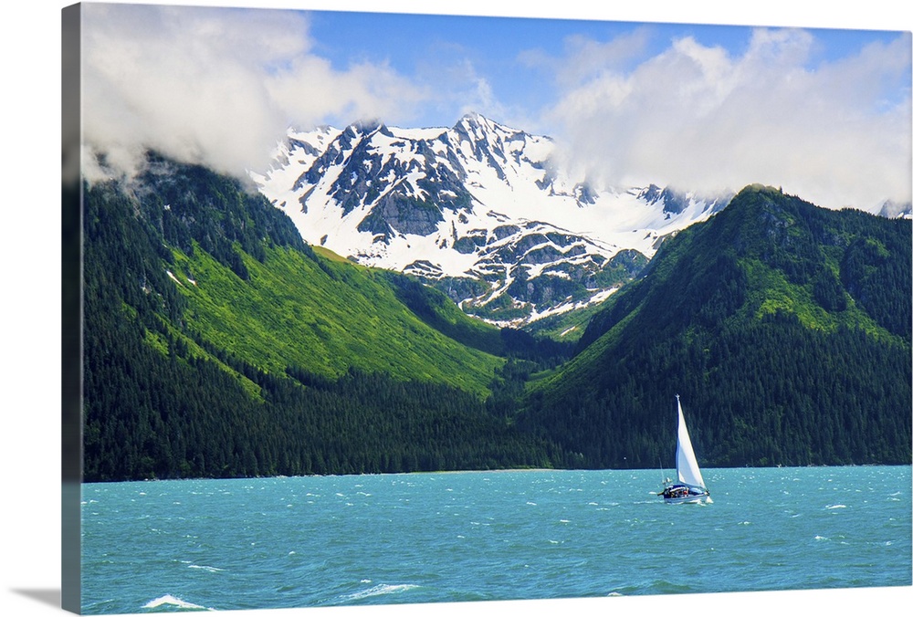 Sailing ship in Resurrection bay with mountains in background, Seward, Alaska, USA.