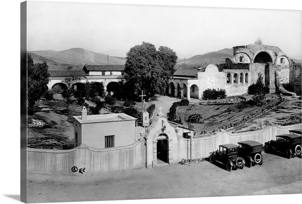 Cars parked outside the walls of San Juan Capistranio Mission, California, May 1921.