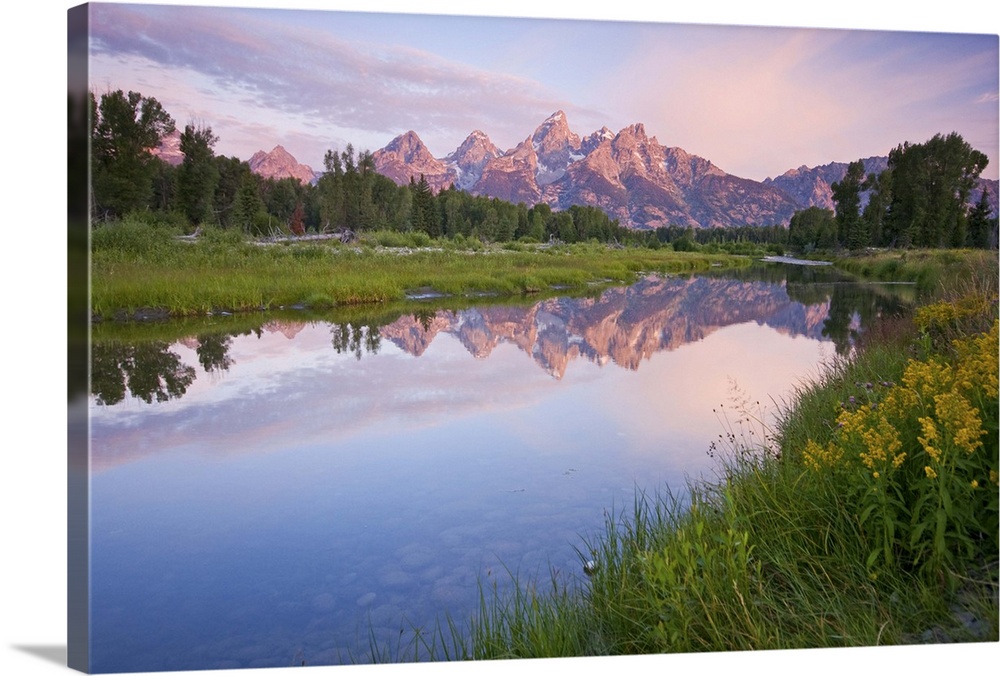 Beautiful cloud and light play on the Grand Tetons reflected in Schwabacher's landing in Wyoming