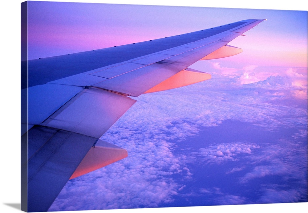 The starboard wing of a Thai Airways International airplane is lit by the setting sun as it flies north of Bangkok. | Loca...