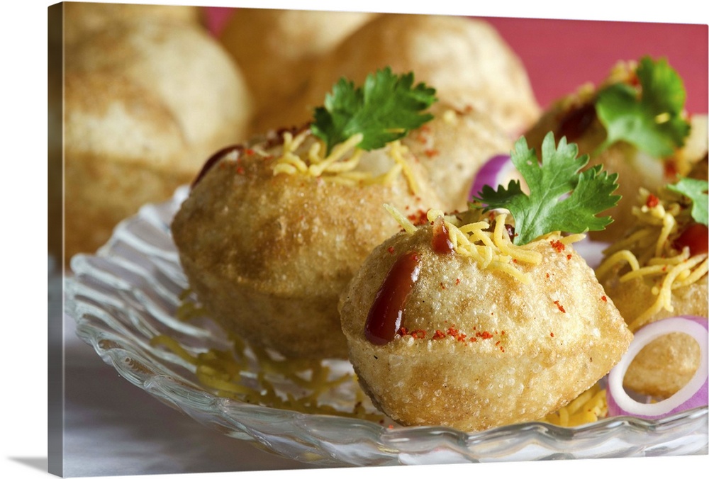 Popular North Indian street food. Pani puri or golgappa served with onions, sev, garnished with coriander. A tangy snack. ...