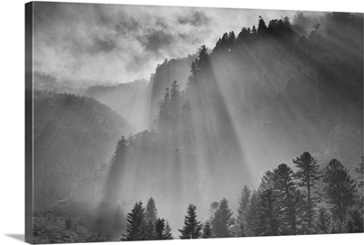 Shafts of light break through clouds in French Pyrenees.
