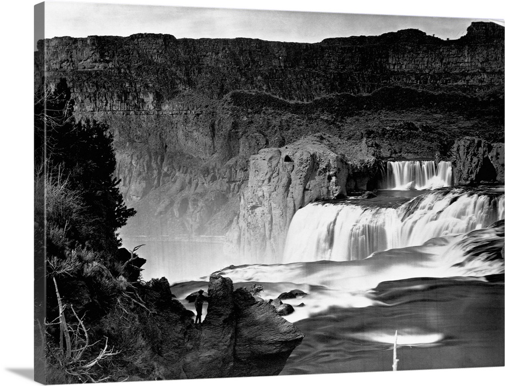A man stands on a rock outcropping overlooking Shoshone Falls, Snake River, Idaho, 1874.
