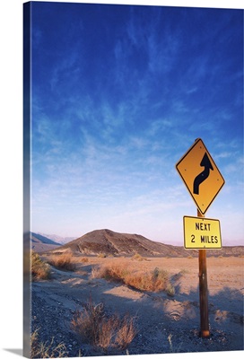 Sign on the death valley road in sunset