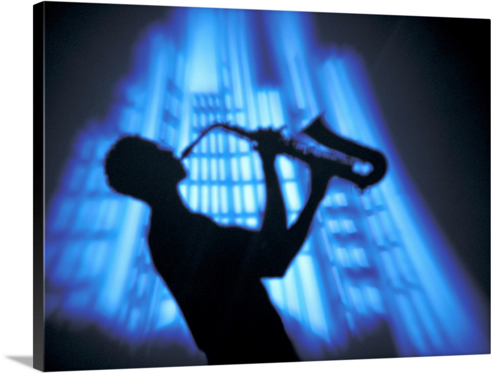 Silhouette man lifting sax into air while playing