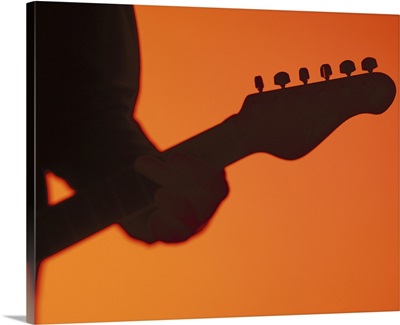 silhouette of a person playing a electric guitar
