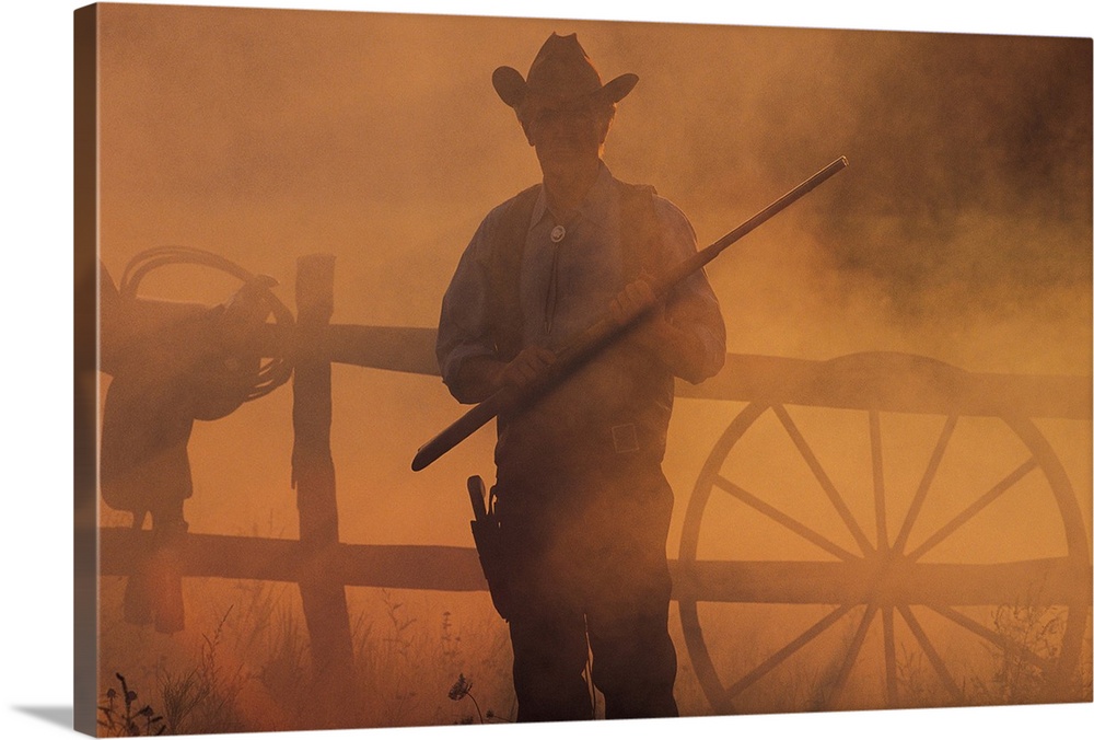 Silhouette of cowboy with rifle in hand