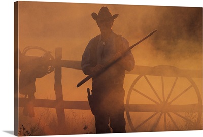 Silhouette of cowboy with rifle in hand