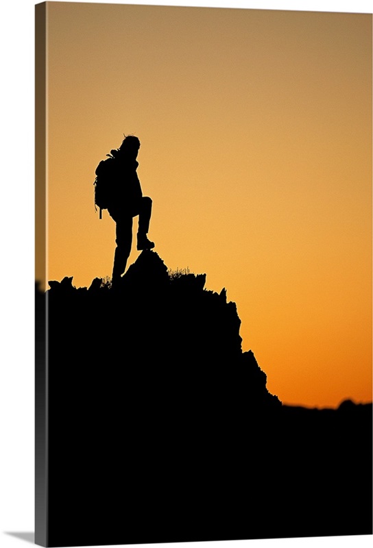 Silhouette of hiker standing on peak at sunset Wall Art, Canvas Prints