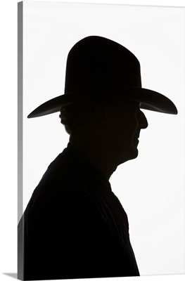 Silhouette Of Man In Profile Wearing Traditional Cowboy Hat With High Crown.