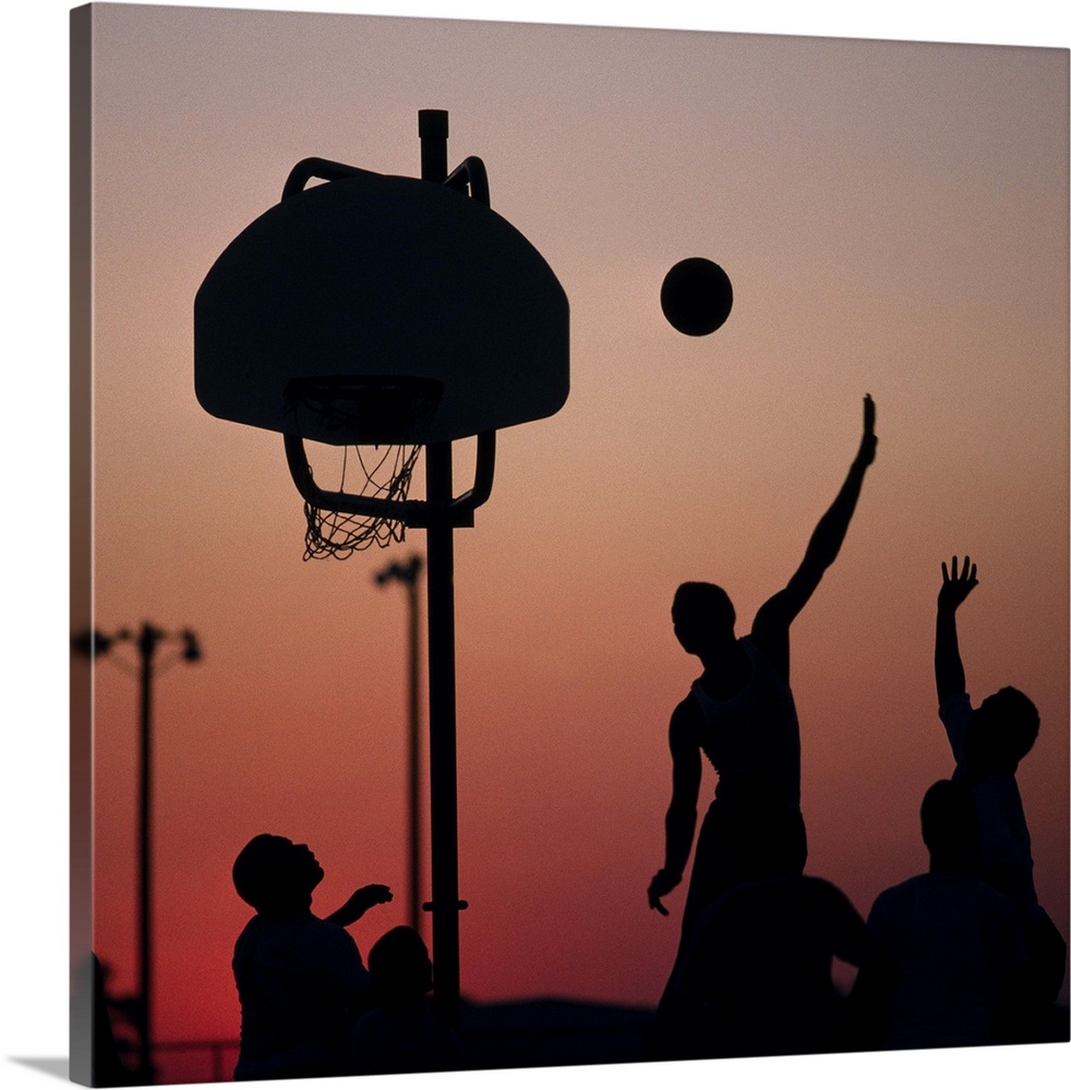 Silhouette of men playing basketball